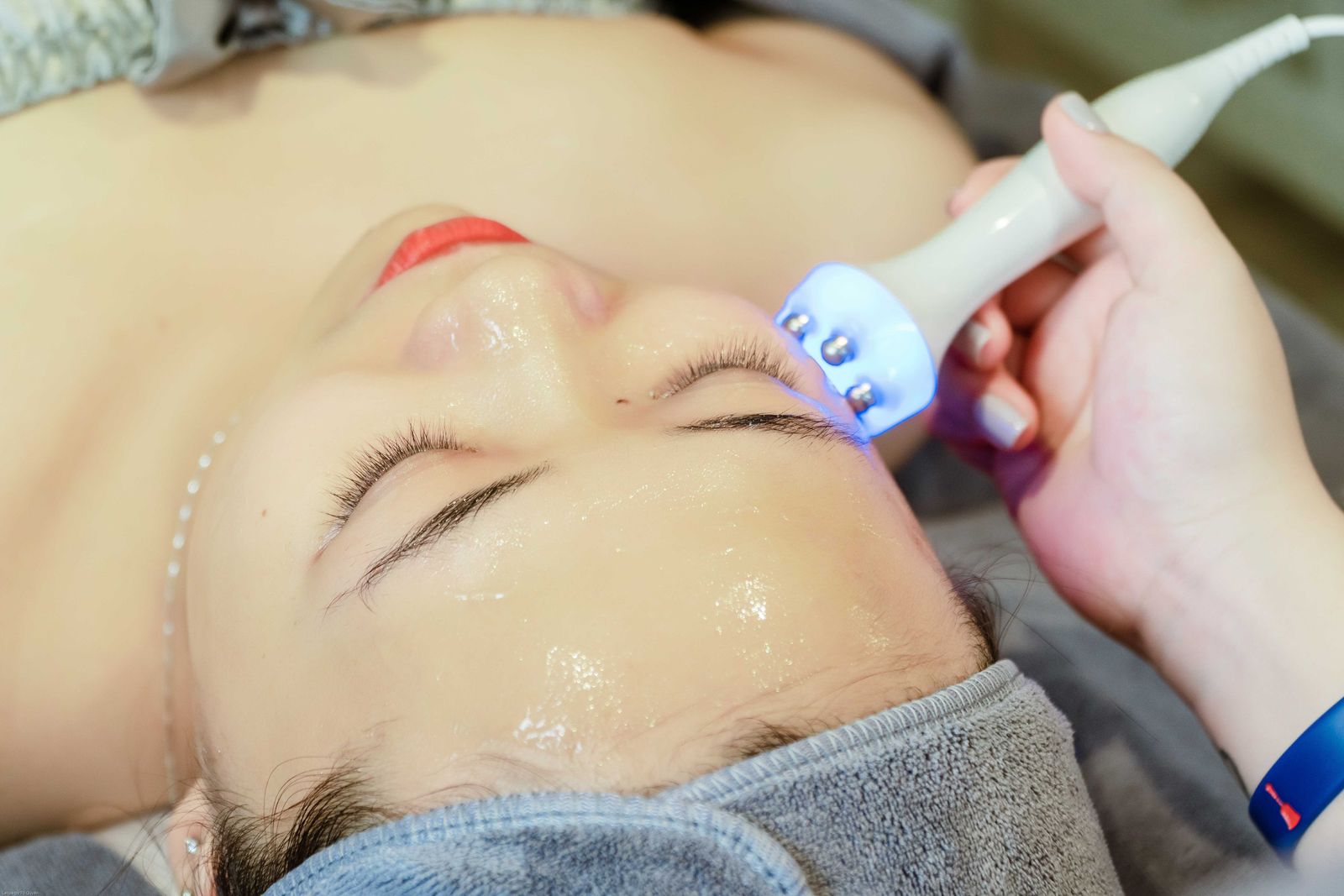 Close-up de uma mulher recebendo um tratamento facial ultrassônico em um spa em Hanói, Vietnã.